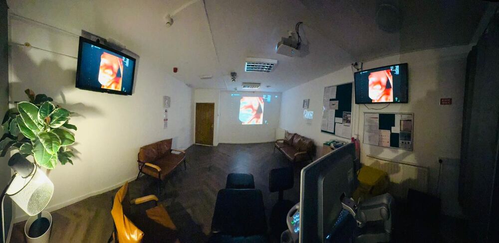Modern private ultrasound scan room with comfortable bed, ultrasound equipment, and warm ambient lighting