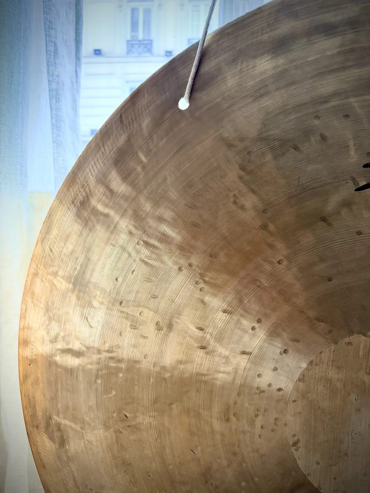 Close-up of a hammered gong surface in daylight