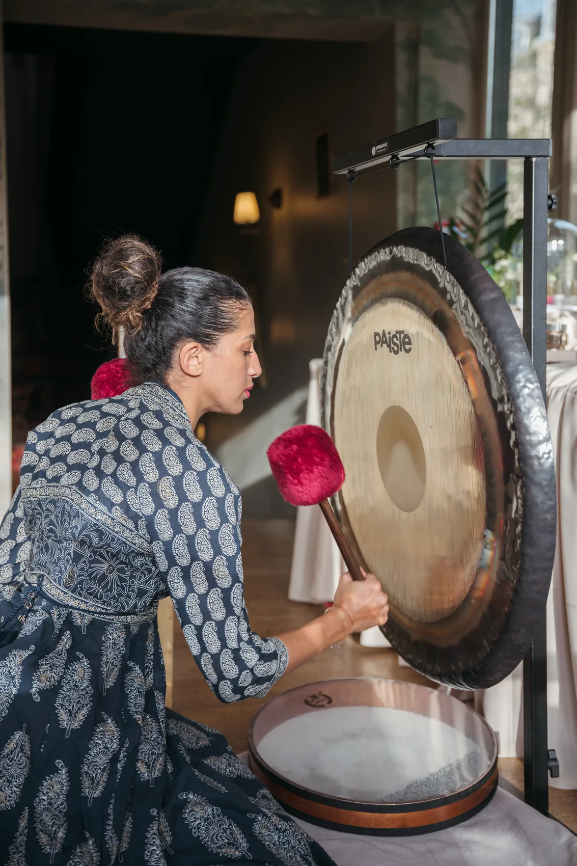 Praticienne jouant du gong lors d'un bain sonore au studio Résonance, Paris 16